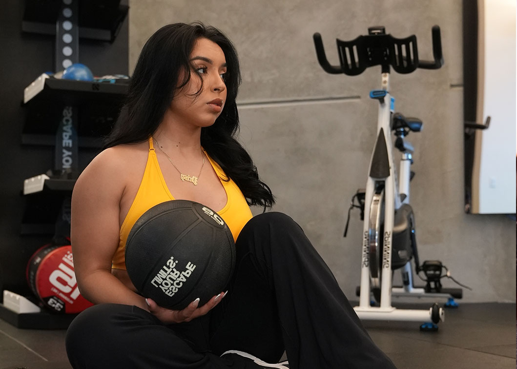 Coach at the gym working out with a ball